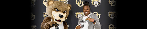 The Grizz mascot poses next to Stephanie Lee