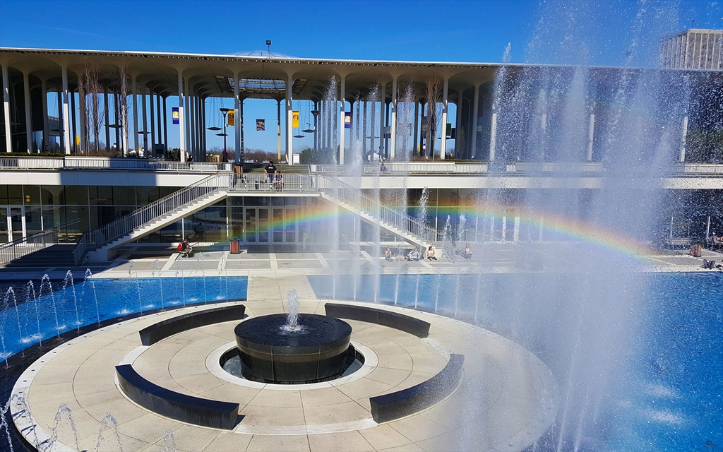 UAlbany fountain at the podium with a rainbow
