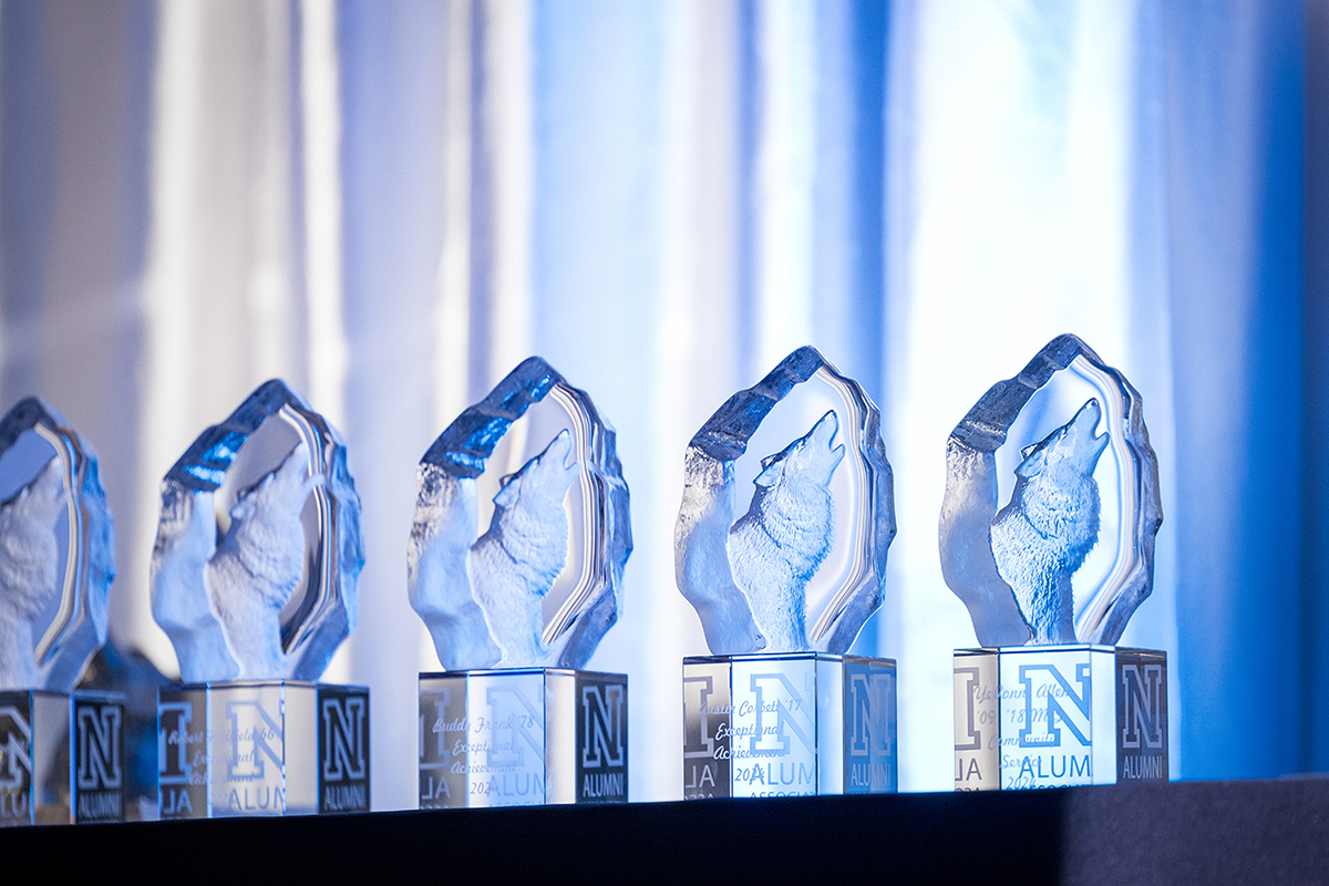 Clear trophies on stand with blue background
