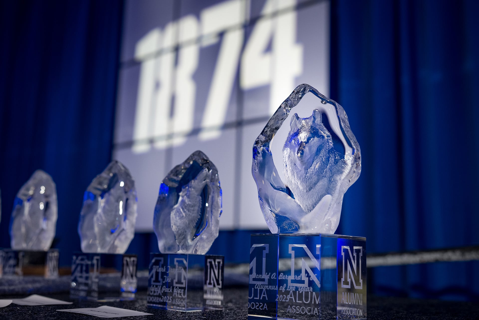 crystalline trophies lined up on a table
